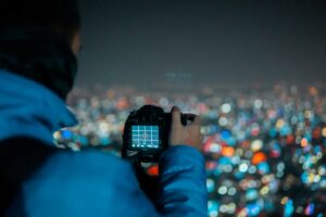 person holding black DSLR camera
