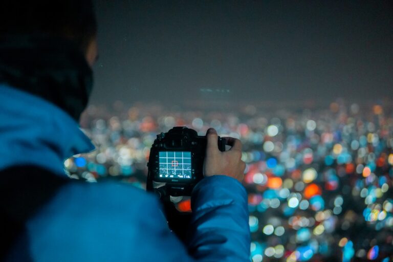person holding black DSLR camera