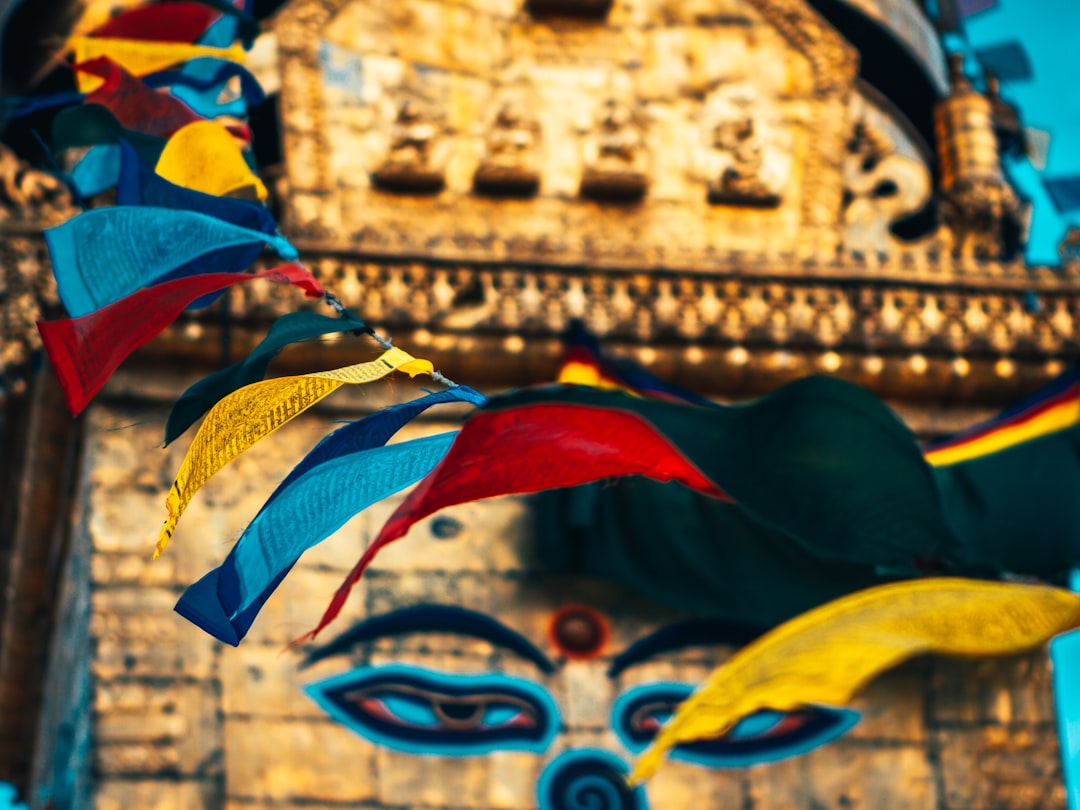 yellow and blue concrete building with flags