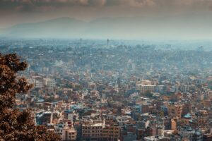 a view of a city with mountains in the background