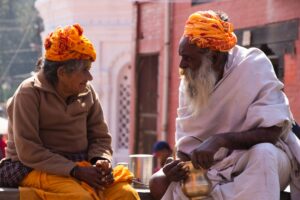 a couple of men sitting next to each other