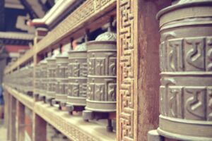 a row of metal bells sitting on top of a wall