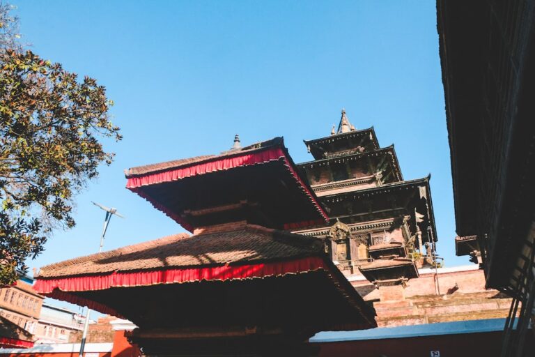 Best Scenic Drives Through Geological Sites in Kathmandu – Travel Guide to Kathmandu 16 a tall building with a red roof next to a tree