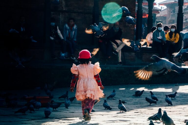 Eco-Friendly Activities in Kathmandu β Travel Guide to Kathmandu 65 a little girl in a pink dress and a bunch of pigeons