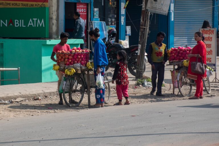 a group of people stand outside a fruit stand