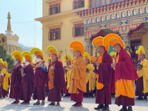 a group of people in robes and hats standing in front of a building