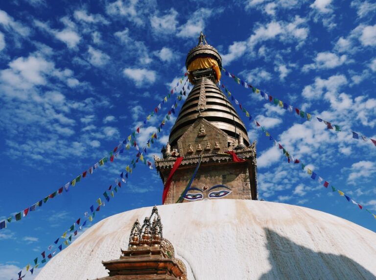 Ultimate Guide to Kathmandu β Travel Guide to Kathmandu 35 Swayambhunath with a tower and flags