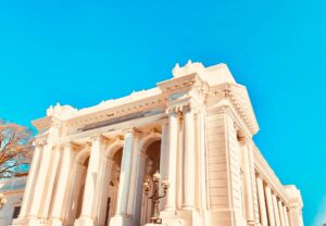 a large white building with a clock on the front of it