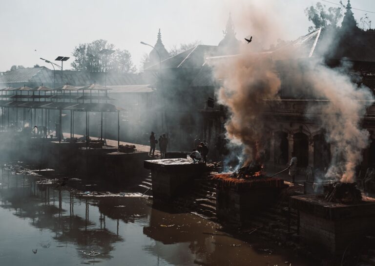 Sustainable Experiences in Kathmandu – Travel Guide to Kathmandu 18 smoke billowing out of a building next to a body of water
