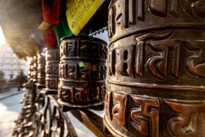 a close up of a metal object with a rainbow in the background
