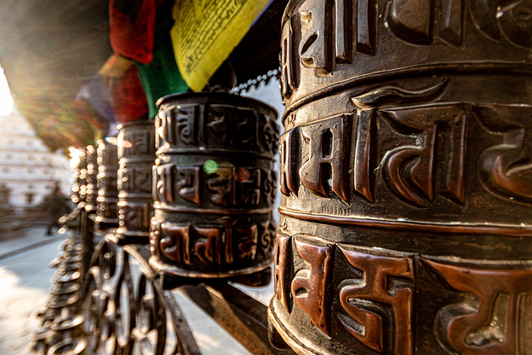 a close up of a metal object with a rainbow in the background