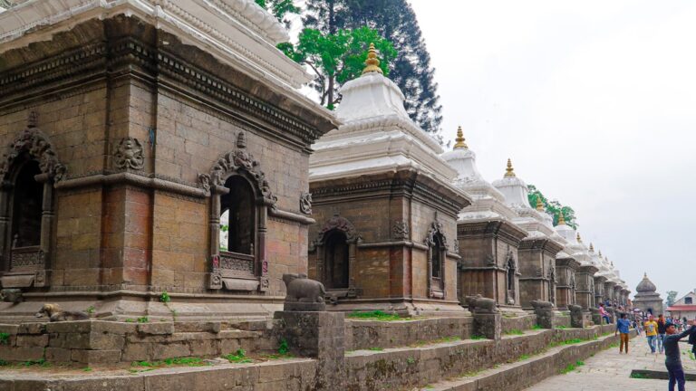 Top 10 Eco-Friendly Activities in Nature Reserves in Kathmandu β Travel Guide to Kathmandu 1 A group of people walking down a street next to tall buildings