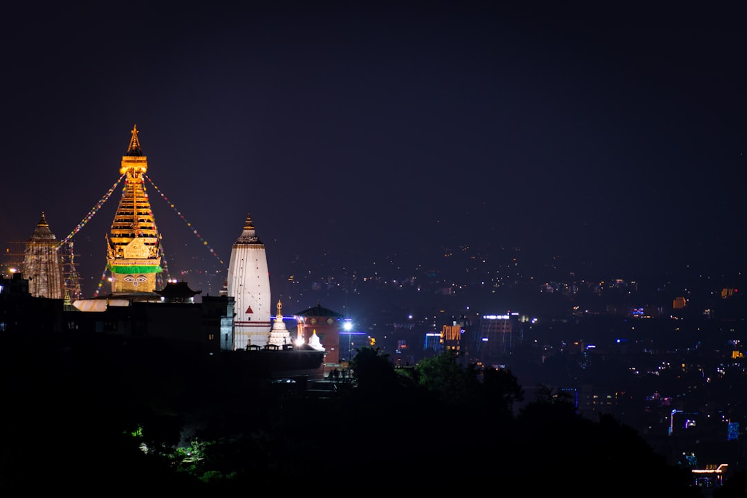 A view of a city at night from a hill