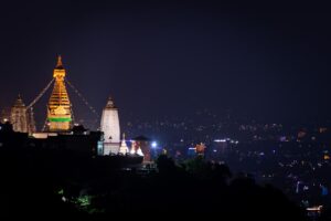 A view of a city at night from a hill