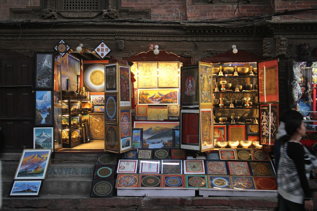 A man walking past a store with a lot of items on display
