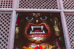 A statue of a demon in a window