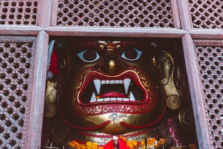 A statue of a demon in a window