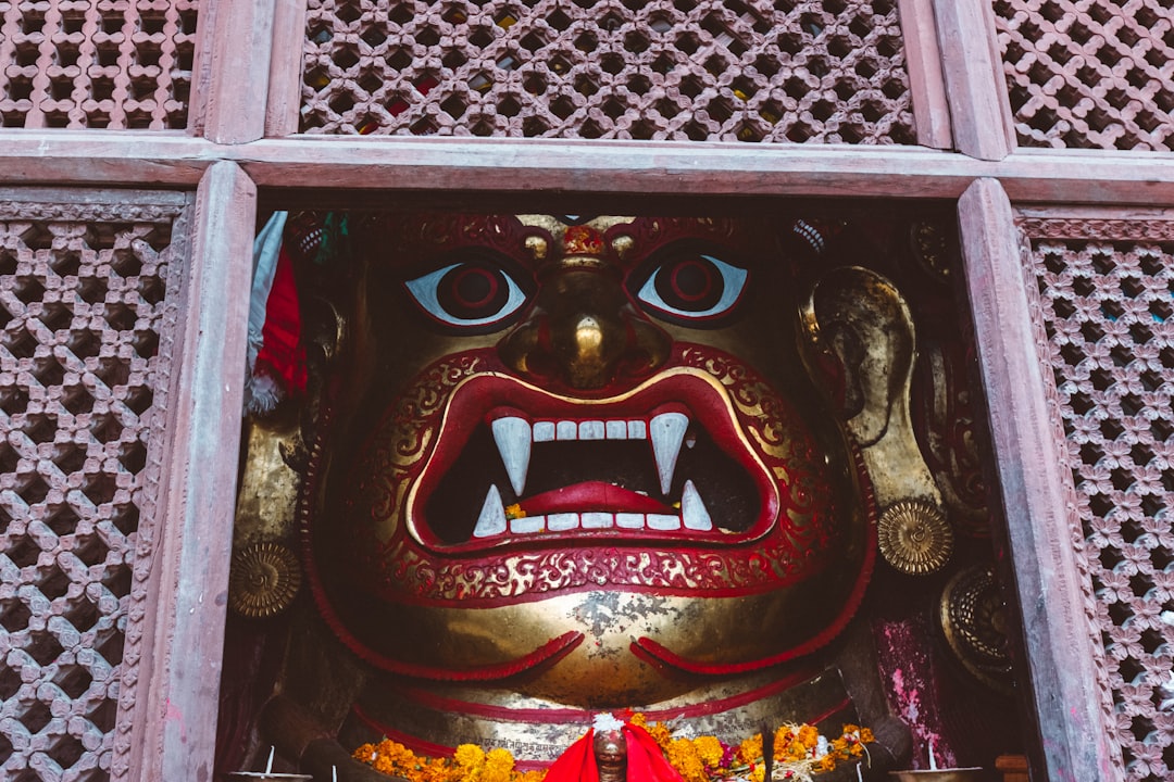 A statue of a demon in a window