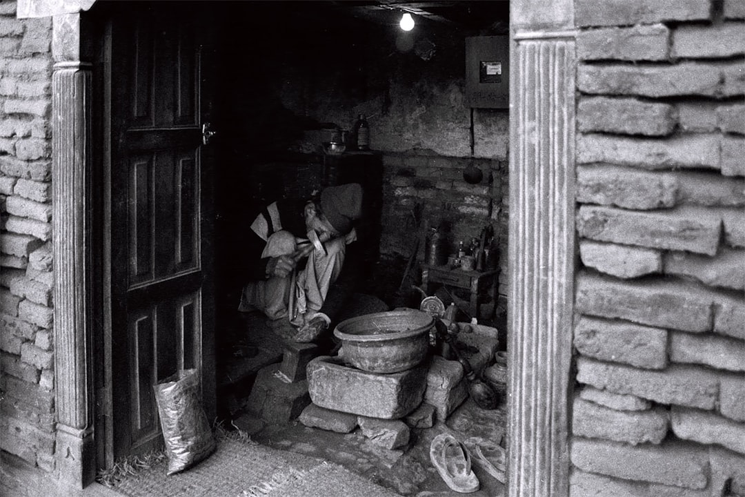 A darkened room shows a person working.