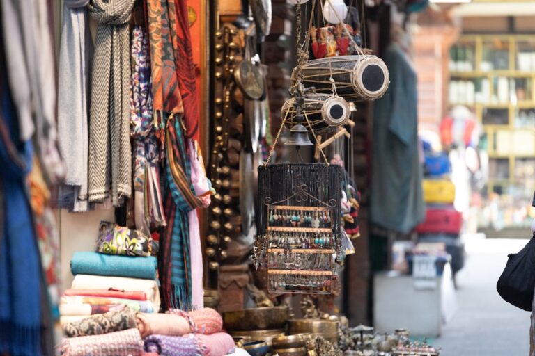 A market stall displays colorful textiles and crafts.