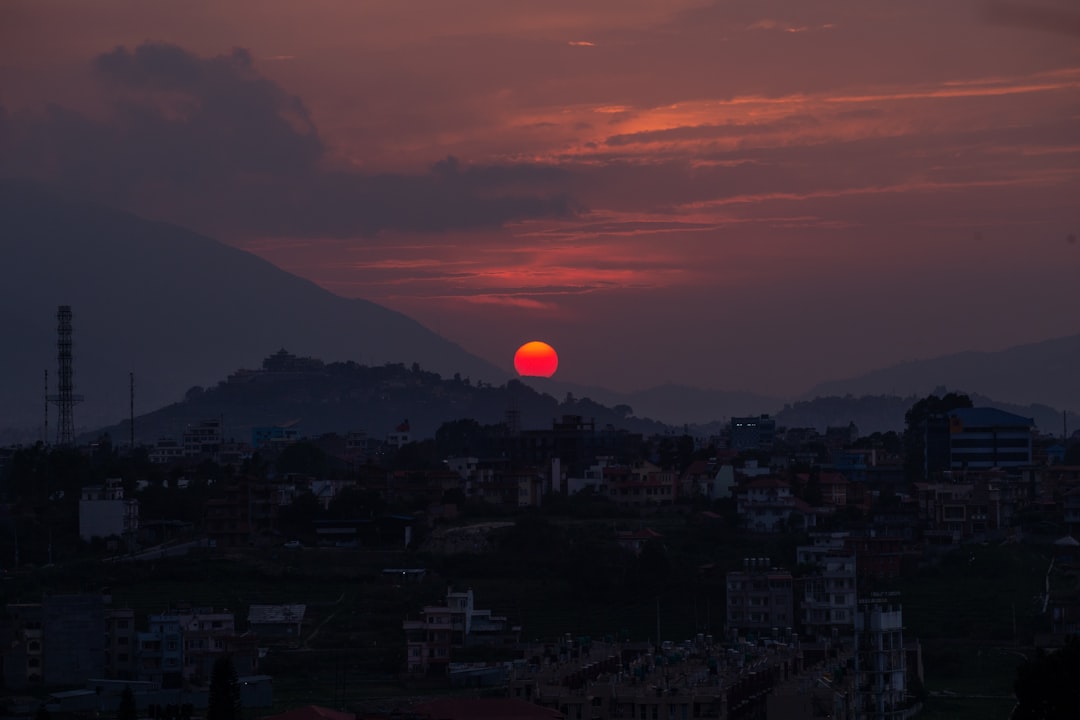 Distant sunset over hazy hills and town