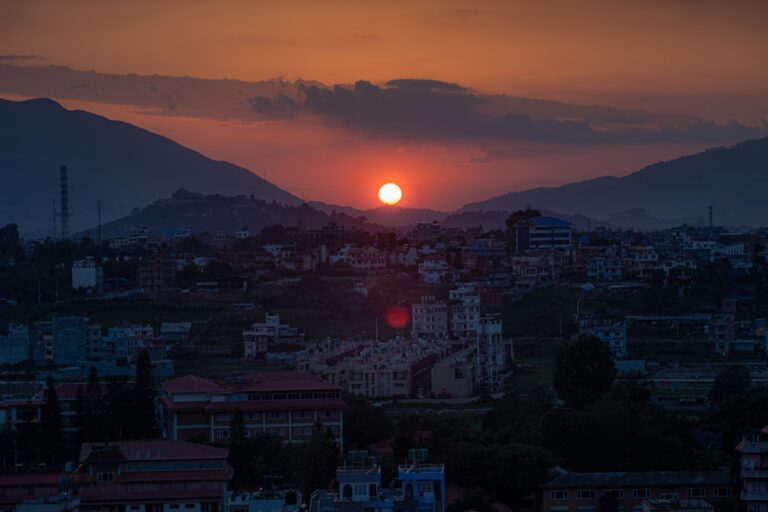 Top 20 Romantic Experiences in Kathmandu โ Travel Guide to Kathmandu 65 Sunset over a hazy cityscape with mountains